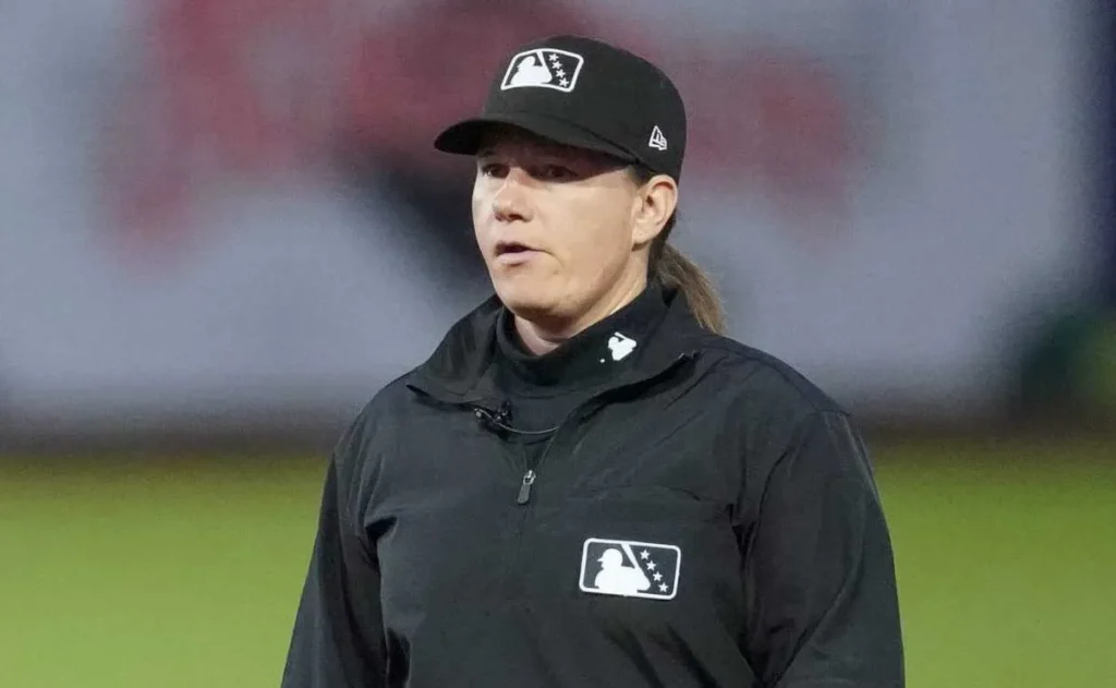 Jen Pawol will make history this weekend as the first woman to umpire a regular-season Major League Baseball game when she officiates during the three-game series between the Miami Marlins and the Atlanta Braves at Truist Park. Pawol, 48, is scheduled to serve on the bases for both games of Saturday’s doubleheader and will take the home plate position on Sunday. She began her umpiring journey in the minor leagues in 2016 after completing her training at the Umpire Training Academy in Vero Beach. In 2023, she reached Triple-A, becoming the first woman at that level in 34 years and was selected as the home-plate umpire for the Triple-A National Championship Game. Her major league experience expanded in 2024 and 2025, when she participated in MLB spring training games, becoming the first woman to do so since Ria Cortesio in 2007. That performance helped secure her place on Major League Baseball’s official call-up list. A native of West Milford, New Jersey, Pawol was a standout athlete at Hofstra University, where she earned All-Conference softball honors. She also played on the USA women’s national baseball team in 2001. With advanced degrees and a background in teaching art, she later transitioned full-time into umpiring, driven by her passion for sports and competition. Major League Baseball confirmed that a fifth umpire would be added to the officiating crew for Saturday’s doubleheader, creating the opportunity for Pawol’s debut. On Sunday, she will serve as the plate umpire for the series finale, marking a significant milestone in professional sports officiating. Her achievement adds to a growing list of gender inclusion milestones across U.S. professional sports. The NBA welcomed its first female referees in 1997, the NFL in 2015, and women have recently officiated in the men’s FIFA World Cup. Major League Baseball now joins the ranks, while the NHL remains the only major league in the U.S. without a female official. The baseball community has welcomed Pawol’s promotion. Dodgers manager Dave Roberts called it “good for the game,” and others praised her poise and professionalism during previous spring training appearances. Her elevation reflects Major League Baseball’s ongoing efforts to promote diversity and inclusion within its officiating ranks. Jen Pawol’s debut is not only a personal triumph but a momentous step for women in sports. As she takes her place on the field, she represents progress, determination, and a future where gender no longer limits opportunity in professional athletics.