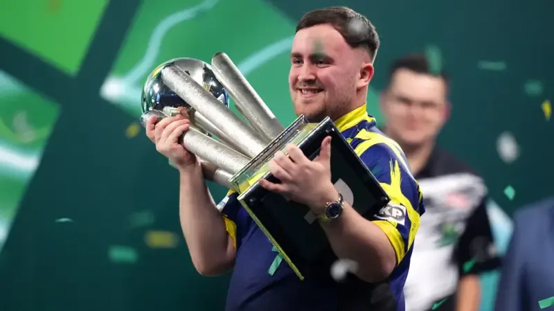 Luke Littler won his second straight PDC World Darts Championship title on Saturday night at London's Alexandra Palace. The eighteen-year-old sensation defeated Dutch rival Gian van Veen with a dominant 7-1 set score to retain his position as the world number one. Despite losing the first set in a close contest, Littler showed incredible resilience by winning the next seven sets in a row. This victory allowed him to claim the prestigious Sid Waddell Trophy and a record-breaking winner's purse of one million pounds. Littler is now the first player to successfully defend this specific world title since Gary Anderson achieved the feat in 2016. His performance throughout the evening was marked by high scoring and clinical finishes that left his opponent with few opportunities to respond. The final match at the iconic Ally Pally venue featured two of the youngest stars in the history of professional darts. Gian van Veen entered the contest in excellent form after his semi-final win over Gary Anderson and initially took a 1-0 lead. The Dutchman survived several set darts from Littler to win the opening set in a final-leg decider. However, the momentum shifted quickly in the second set as Littler began to find his rhythm with a series of 180s. The young Englishman won ten consecutive legs during one phase of the match to build a commanding lead over his opponent. His match average remained above 105 for most of the night, highlighting the consistent power of his scoring visits. +1 Van Veen continued to throw high-quality darts but struggled to keep pace with the relentless accuracy of the defending champion. The Dutch star maintained an average of over 100 throughout the final but found himself under pressure on nearly every visit to the board. A standout moment in the match occurred during the final set when Littler completed a magnificent 147 checkout to seal his dominance. This remarkable finish brought the crowd to their feet and served as a reminder of the generational talent Littler possesses. While Van Veen managed to land several maximums and showed great fighting spirit, he was unable to break Littler’s rhythm as the sets continued to go in favor of the Englishman. The triumph marks another significant milestone for the player known to fans as The Nuke. Since reaching the final as a teenager in 2024 and winning his first world title in 2025, Littler has become a global phenomenon. His ability to remain calm under the intense pressure of a world final has redefined the expectations for young players in the sport. The rivalry between Littler and Van Veen is expected to be a major narrative in professional darts for many years to come. Following the final double, Littler celebrated with his family and supporters while the fans at Alexandra Palace chanted his name. He is now officially the youngest player to ever win multiple world championships in the history of the PDC. The trophy presentation capped off a historic night for the sport as the prize money for the event reached new heights. The increased financial rewards and record television viewership reflect the massive growth of darts under the influence of its new stars. Littler remarked after the match that the prestige of the trophy was his main goal rather than the financial gain. He expressed a desire to continue his winning streak and stay at the top of the world rankings for as long as possible. Gian van Veen moves up to world number three following his impressive performance in this year's tournament and will likely be a top contender in future major events. For now, Luke Littler stands alone as the undisputed king of the darting world.